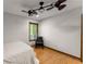 Comfortable bedroom featuring natural light, hardwood floors, chair and ceiling fans at 440 Hunt River Way, Suwanee, GA 30024