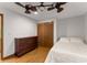 Bedroom showcasing hardwood floors, closet, dresser, ceiling fan and ample lighting at 440 Hunt River Way, Suwanee, GA 30024
