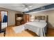Bedroom with hardwood floors, ceiling fan, and stylish headboard, offering a serene retreat at 440 Hunt River Way, Suwanee, GA 30024