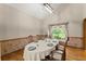 Dining room features natural light, hardwood floors, and elegant wainscoting at 440 Hunt River Way, Suwanee, GA 30024