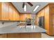 Bright kitchen featuring light wood cabinets, stainless steel appliances, and gray countertops at 440 Hunt River Way, Suwanee, GA 30024