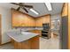 Bright kitchen featuring light wood cabinets, stainless steel appliances, and gray countertops at 440 Hunt River Way, Suwanee, GA 30024