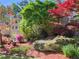 Beautiful landscaping with colorful plants and mature trees surrounding this lovely home at 440 Hunt River Way, Suwanee, GA 30024