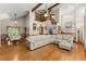 Open-concept living room with hardwood floors, vaulted ceiling, and an adjacent dining area at 440 Hunt River Way, Suwanee, GA 30024