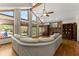 Bright living room with large windows, vaulted ceiling, and a cozy stone fireplace at 440 Hunt River Way, Suwanee, GA 30024