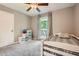 Bedroom featuring carpet flooring, ceiling fan, and a window with backyard view at 1206 Parkwood Chase, Acworth, GA 30102