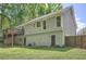 Back exterior showing well-maintained yard and multiple windows and doors leading to outdoor deck at 1206 Parkwood Chase, Acworth, GA 30102