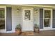 Inviting front entryway with decorative door, potted plants and stylish outdoor lighting creates a welcoming atmosphere at 1206 Parkwood Chase, Acworth, GA 30102