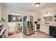 Bright kitchen featuring stainless steel refrigerator, white cabinetry, and tiled backsplash at 1206 Parkwood Chase, Acworth, GA 30102