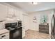 Clean kitchen with white cabinets, black appliances, subway tile backsplash, and a window view at 1206 Parkwood Chase, Acworth, GA 30102