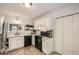 Bright kitchen with white cabinets, black appliances, subway tile backsplash, and stainless steel refrigerator at 1206 Parkwood Chase, Acworth, GA 30102