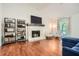 Bright living room features a stone fireplace, hardwood floors, and plenty of space for Gathering and friends at 1206 Parkwood Chase, Acworth, GA 30102