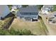 Aerial view of a large backyard with a patio, grass, and a privacy fence, perfect for outdoor living at 1318 Crestwind Nw Rd, Kennesaw, GA 30152