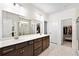 Modern bathroom featuring double sinks, dark wood cabinets, and a large mirror at 1318 Crestwind Nw Rd, Kennesaw, GA 30152
