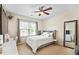 Cozy bedroom with a decorative headboard, ceiling fan, soft colors and plenty of natural light at 1318 Crestwind Nw Rd, Kennesaw, GA 30152
