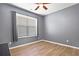 Bedroom with ceiling fan, window with blinds, and wood-look flooring at 1318 Crestwind Nw Rd, Kennesaw, GA 30152