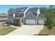 Well-maintained two-story home with a spacious driveway, two-car garage, and beautifully landscaped front yard at 1318 Crestwind Nw Rd, Kennesaw, GA 30152