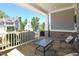 Inviting front porch with stone accents, seating area, and view of the landscaped yard and neighborhood at 1318 Crestwind Nw Rd, Kennesaw, GA 30152