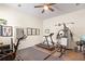 A spacious home gym with a ceiling fan, full set of free weights, treadmill and stationary bike at 1318 Crestwind Nw Rd, Kennesaw, GA 30152