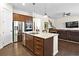 Spacious kitchen island featuring stainless steel appliances, granite countertops, and wood flooring at 1318 Crestwind Nw Rd, Kennesaw, GA 30152