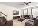 Comfortable living room with a ceiling fan, fireplace, lots of natural light and leather seating at 1318 Crestwind Nw Rd, Kennesaw, GA 30152
