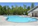 A sparkling swimming pool with lounge chairs and shade, perfect for relaxing during the day at 1318 Crestwind Nw Rd, Kennesaw, GA 30152
