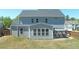 A beautiful home featuring a gray exterior, a covered patio, and a well-maintained backyard at 1318 Crestwind Nw Rd, Kennesaw, GA 30152