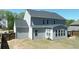Back exterior showing large backyard, gazebo, gray siding, and windows at 1318 Crestwind Nw Rd, Kennesaw, GA 30152