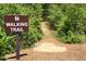 Entrance to the community's walking trail; a serene nature path through lush greenery at 1318 Crestwind Nw Rd, Kennesaw, GA 30152