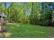 Expansive backyard featuring a playhouse and lush greenery, perfect for outdoor activities and relaxation at 4505 Glengary Ne Dr, Atlanta, GA 30342