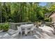 Outdoor deck features an eating area and a stainless steel grill surrounded by lush greenery, perfect for dining al fresco at 4505 Glengary Ne Dr, Atlanta, GA 30342