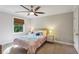 Cozy bedroom featuring neutral walls, a decorative ceiling fan, and a window with a woven shade at 4505 Glengary Ne Dr, Atlanta, GA 30342