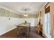 Bright dining room with decorative wallpaper, hardwood floors, and ample natural light from large windows at 4505 Glengary Ne Dr, Atlanta, GA 30342