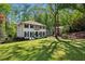 Charming two-story home with a landscaped yard and a classic white facade, surrounded by mature trees at 4505 Glengary Ne Dr, Atlanta, GA 30342