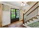 Inviting foyer with patterned wallpaper, hardwood floors, and a staircase, creating a warm entrance at 4505 Glengary Ne Dr, Atlanta, GA 30342