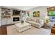 Cozy living room with a brick fireplace, built-in shelves, and large windows overlooking the backyard at 4505 Glengary Ne Dr, Atlanta, GA 30342
