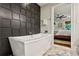Luxurious main bathroom with a modern soaking tub and an accent wall, creating a spa-like atmosphere at 4505 Glengary Ne Dr, Atlanta, GA 30342