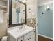 This bathroom has a white vanity, large mirror, and mosaic backsplash at 5400 Roswell Rd # H5, Atlanta, GA 30342