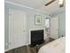 Bright bedroom featuring a fireplace, neutral colors, and wood-look flooring at 5400 Roswell Rd # H5, Atlanta, GA 30342