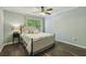 This bedroom offers a ceiling fan, a neutral color palette, and a large window at 5400 Roswell Rd # H5, Atlanta, GA 30342