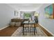 Comfortable dining area near a living room and a sliding glass door to a patio at 5400 Roswell Rd # H5, Atlanta, GA 30342