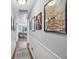 Inviting hallway with hardwood floors, wainscoting, and art at 5400 Roswell Rd # H5, Atlanta, GA 30342