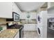 Functional kitchen with modern appliances and a stackable washer and dryer at 5400 Roswell Rd # H5, Atlanta, GA 30342