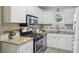 Updated kitchen with stainless steel appliances, granite countertops, and white cabinets at 5400 Roswell Rd # H5, Atlanta, GA 30342