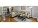 Spacious living room with hardwood floors and an open view to the kitchen at 5400 Roswell Rd # H5, Atlanta, GA 30342