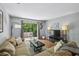 Cozy living room with large sofa, patio access, and ample natural light at 5400 Roswell Rd # H5, Atlanta, GA 30342