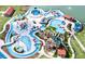 Aerial view of a vibrant water park with colorful slides, pools, cabanas, and lush landscaping at 8531 Spivey Village Trl, Jonesboro, GA 30236