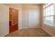 Carpeted bedroom featuring a large window, a closet, and access to an ensuite bathroom at 8531 Spivey Village Trl, Jonesboro, GA 30236
