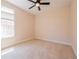 Carpeted bedroom with a ceiling fan and a large window providing natural light at 8531 Spivey Village Trl, Jonesboro, GA 30236