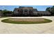 Grand estate home featuring a circular driveway, impressive facade, and meticulously landscaped front yard at 8531 Spivey Village Trl, Jonesboro, GA 30236